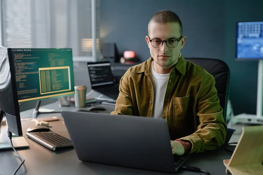 Male it developer in glasses coding on laptop whil 2025 03 09 05 54 56 utc